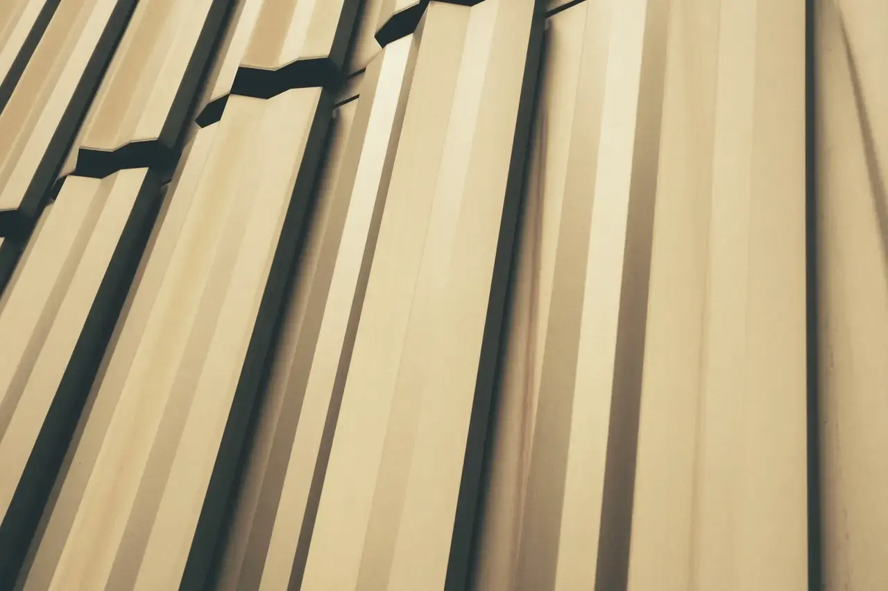 Gold PVD-coloured metal panels in a geometric pattern