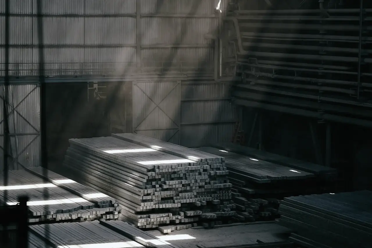 Slit stainless strips and sections stacked in a sunlit warehouse