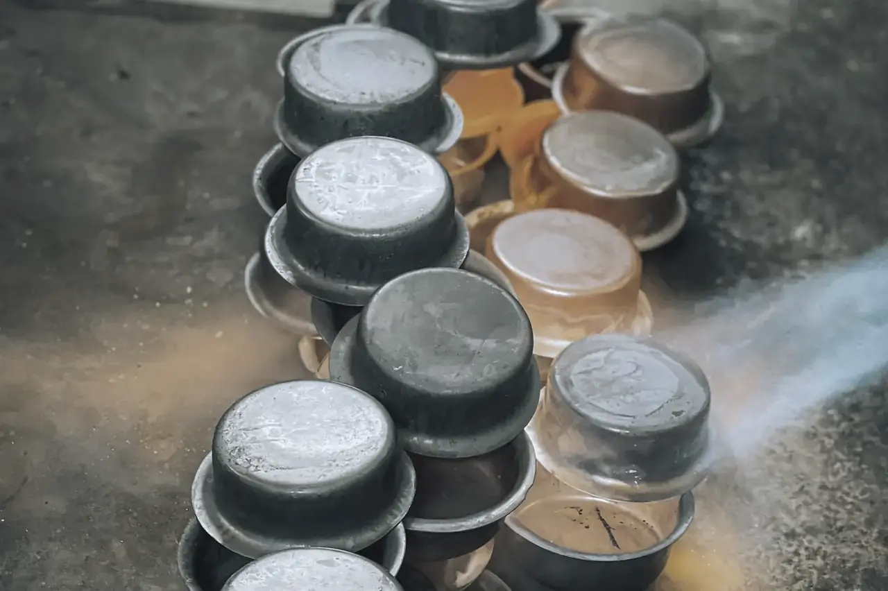 Stainless steel circles being formed into utensils with heat