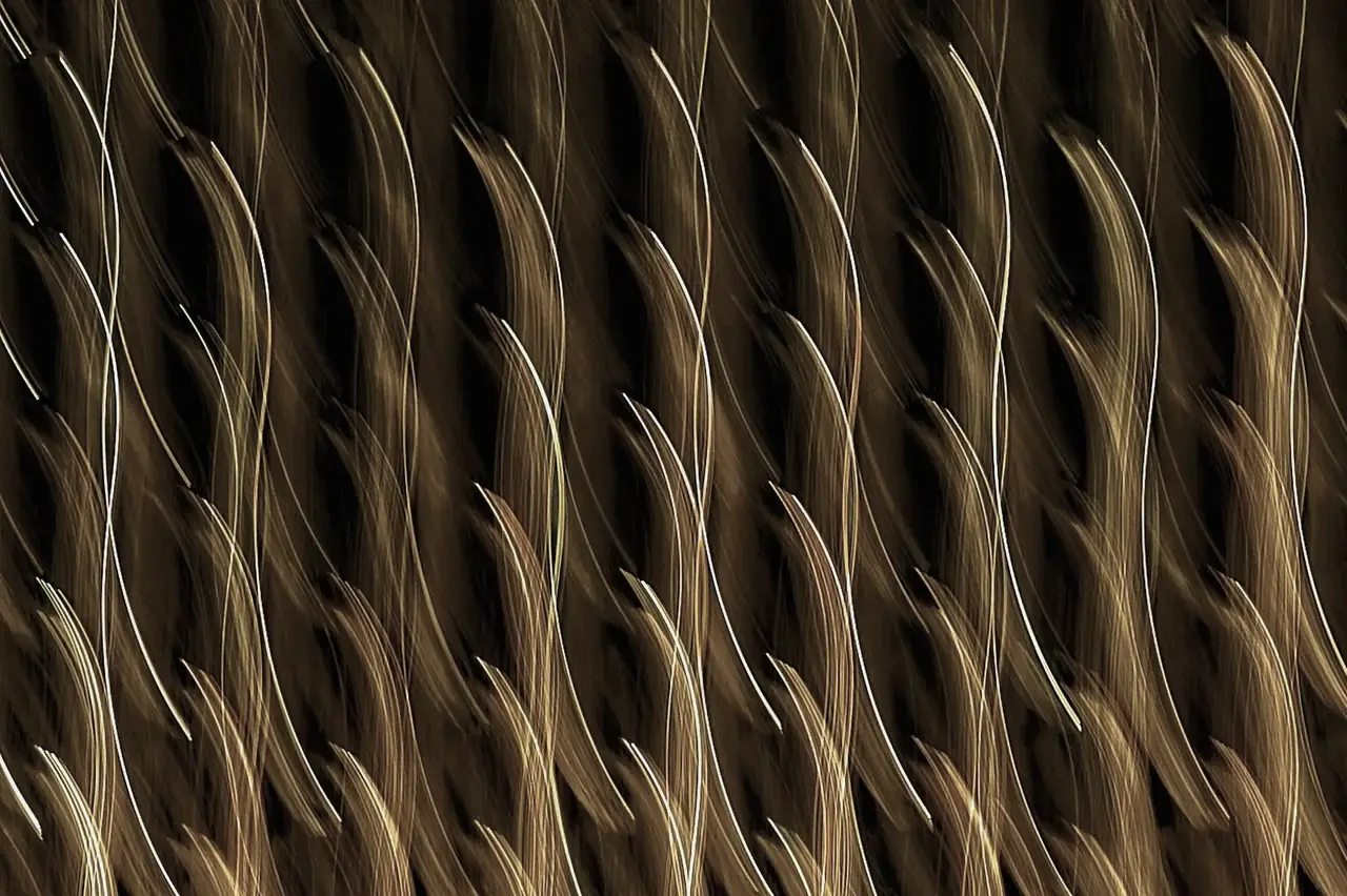 Water-ripple patterned metal surface in warm gold tone
